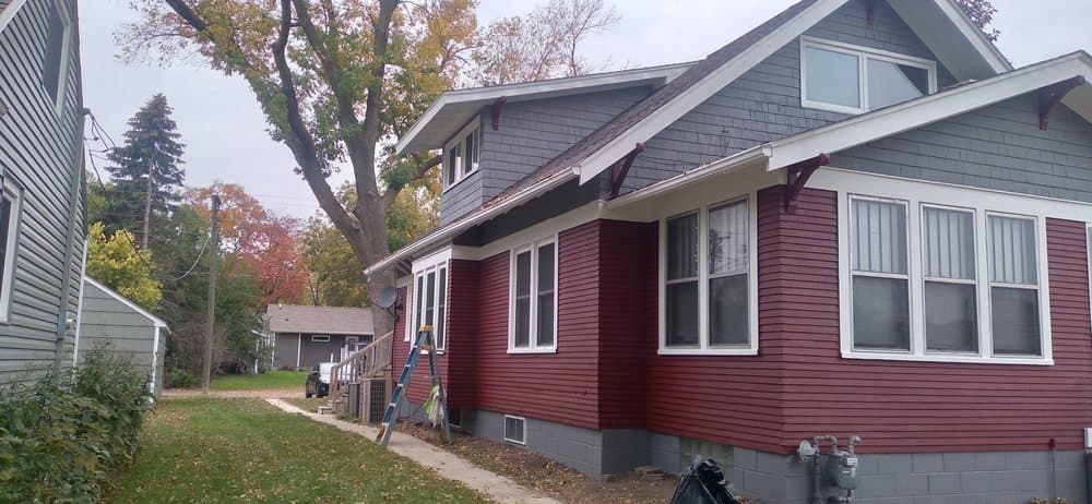 Exterior repaint, red siding with white trim
